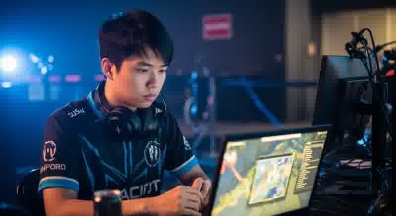 Pro player sitting backstage with a headset in hand, looking tired